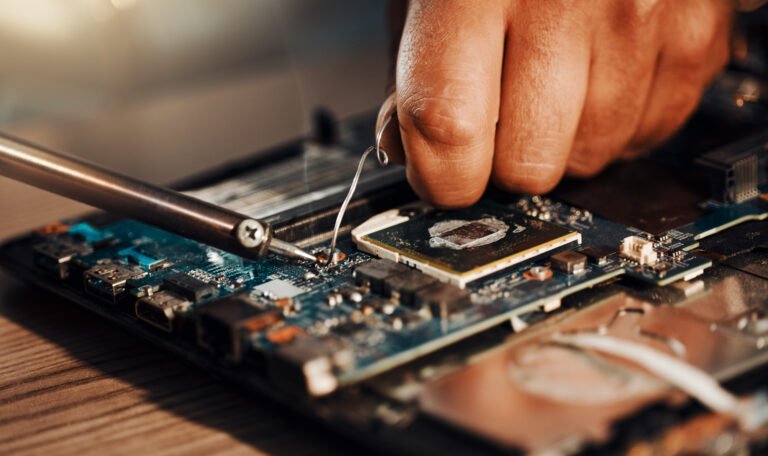 information-technology-hands-motherboard-solderin