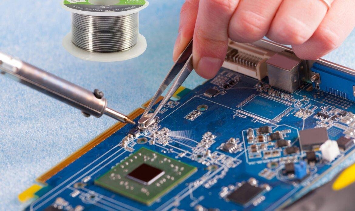 Soldering electronic components on a circuit board with iron and tweezers