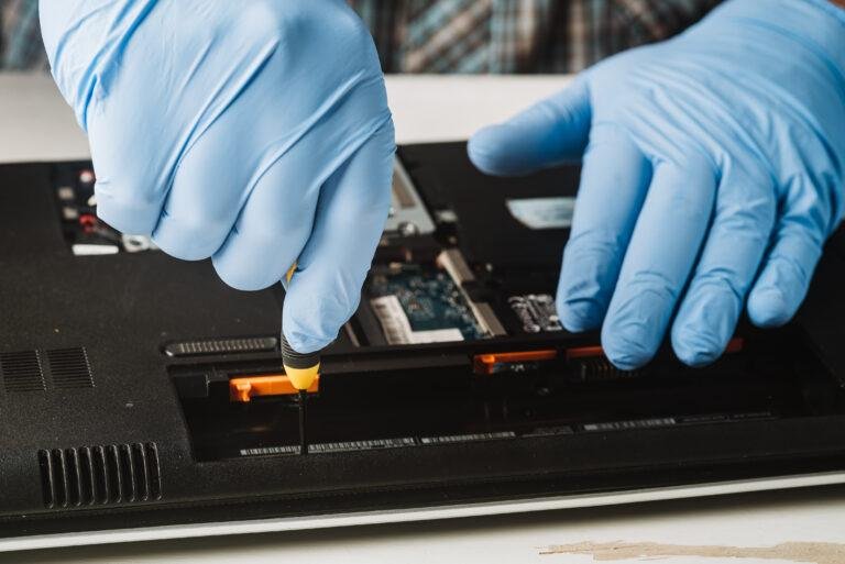 using screwdriver to repair a laptop interior