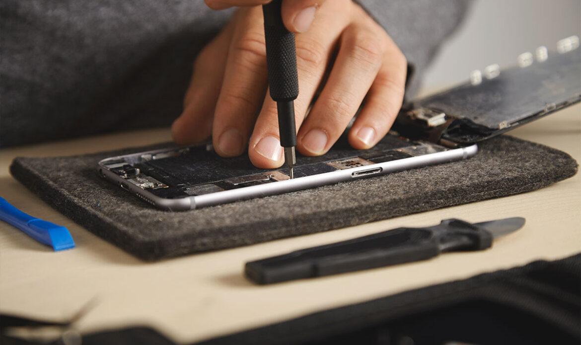 Technician repairing smartphone
