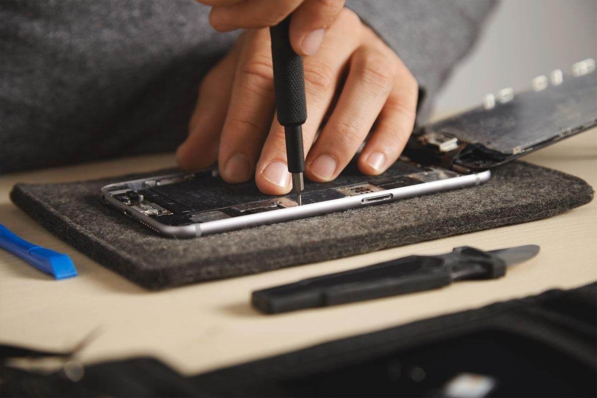 Technician repairing smartphone