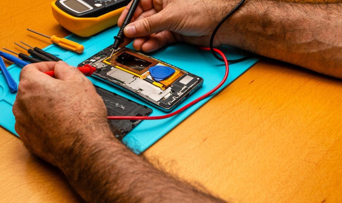 Technician repair mobile phone in electronic smart