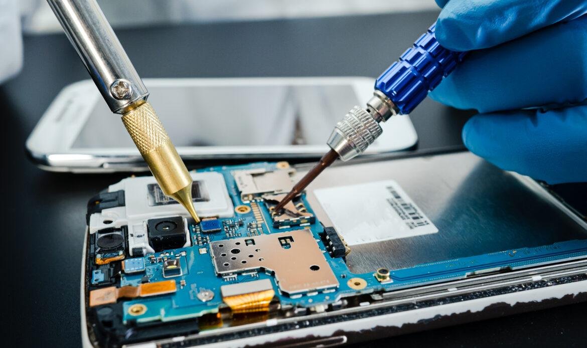 technician repairing inside of hard disk by soldering iron